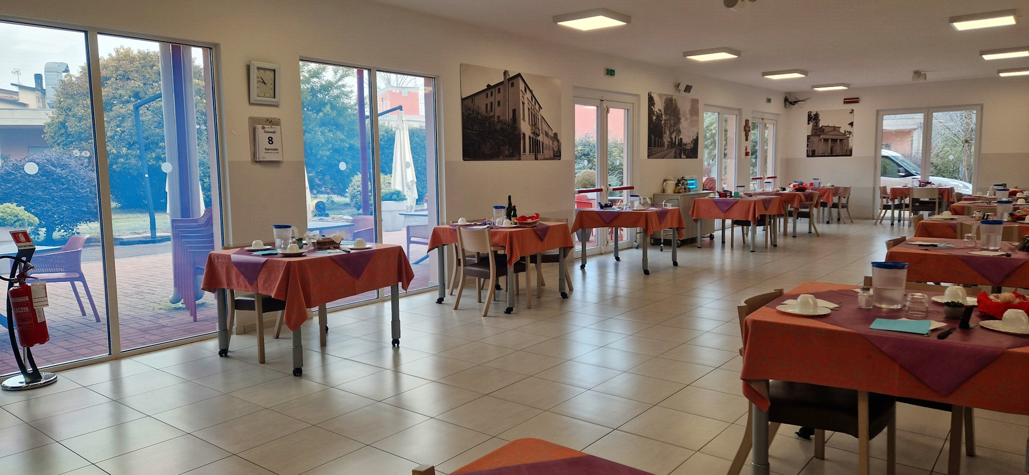 Stanza con tavolini preparati per il pasto